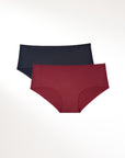 Two pairs of seamless sustainable underwear, one black and one burgundy, on a white background.