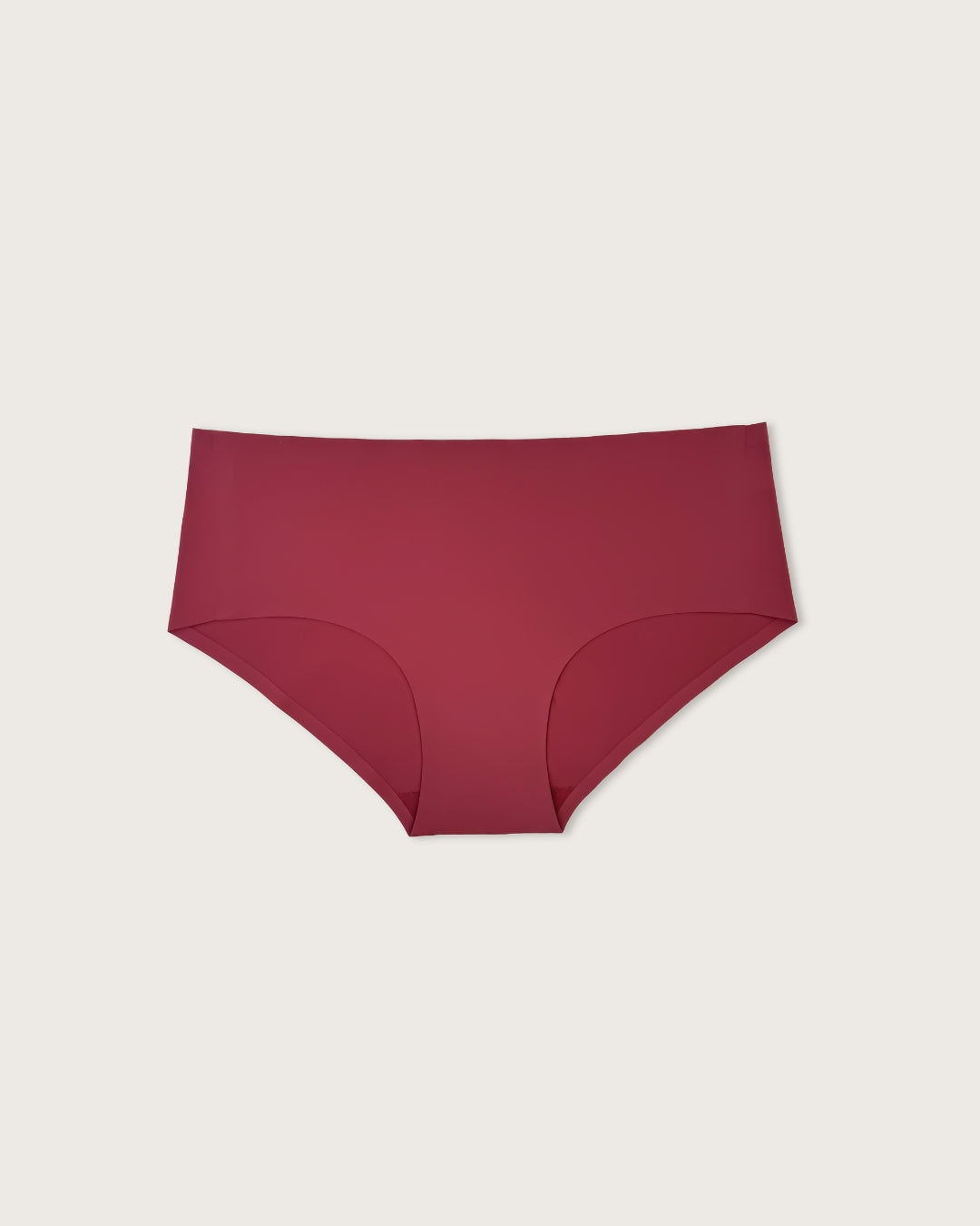 Maroon underwear on a light beige background