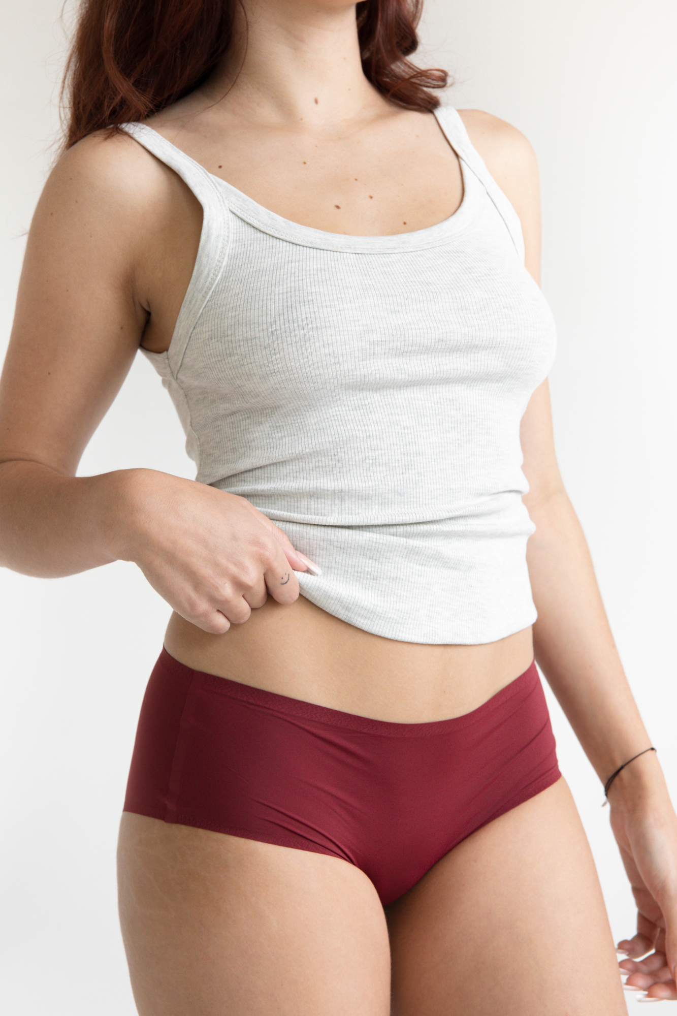 Model in sustainable burgundy seamless undies that don't ride up