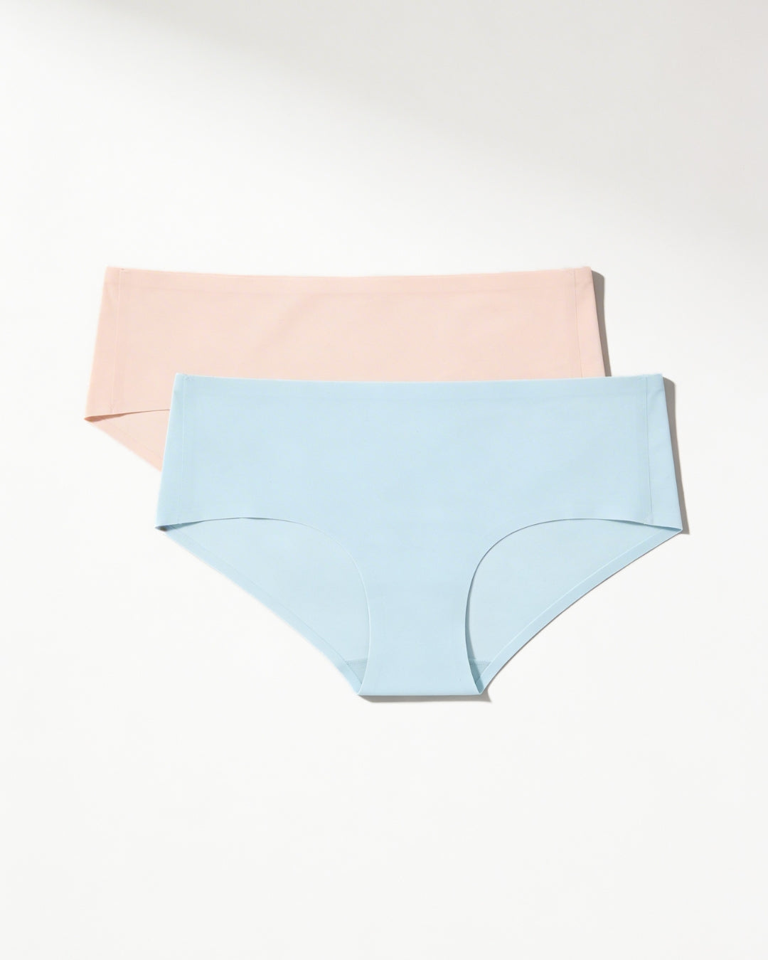 Light blue and beige women's seamless underwear on a white background