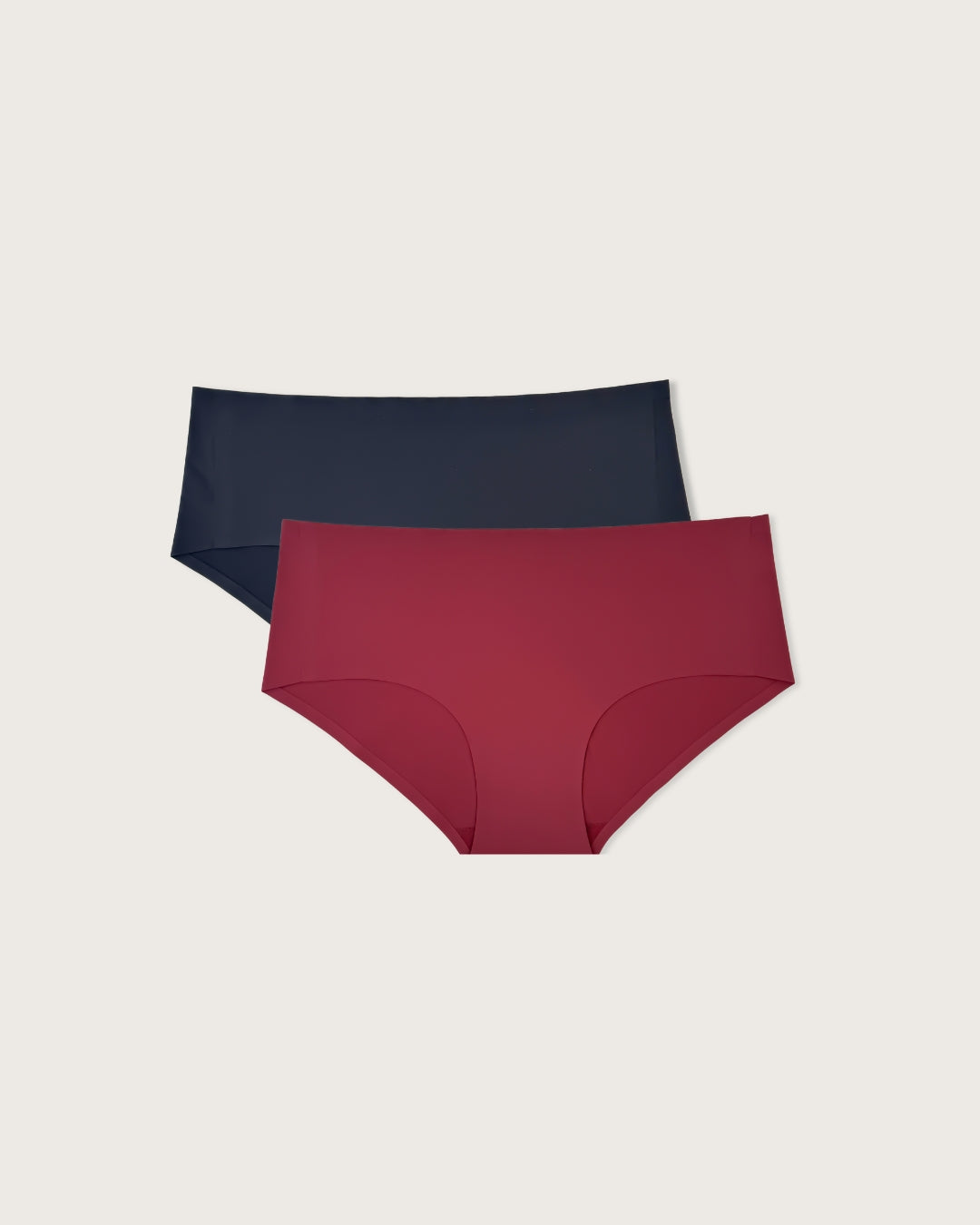 Pack of seamless underwear, one black and one burgundy, on a light gray background.