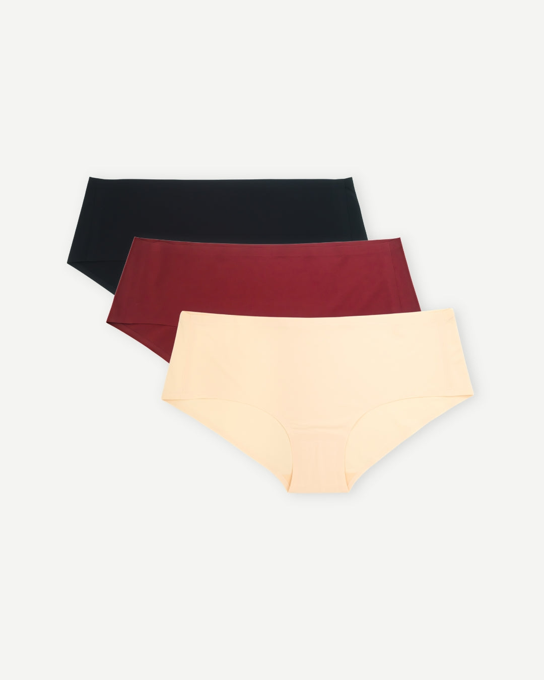 Set of three seamless sustainable undies in black, burgundy, and tan